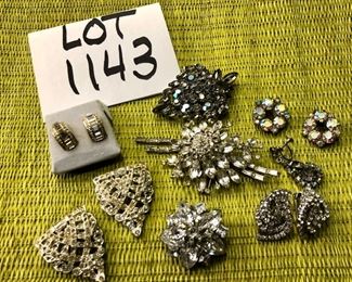 Lot 1143.  Rhinestone jewelry lot.  3 broaches, 4 pairs of earrings and 1 singleton earring.  $40