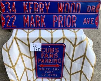 Lot 1215. Set of 3 metal Cubs signs: Cubs fan parking 17-7/8" x 11-7/8"; Prior and Wood street signs 5-7/8" x 36" each.  $60 for the 3