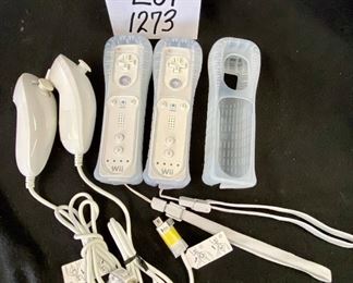 Lot 1273. Buy it Now 32.00  2 Nintendo Wii Remote Controllers, 2 Nunchucks and 1 extra silicone cover