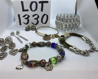 Lot 1330.  $60.00. A large lot of costume jewelry. one pair Swarovski earrings, one pair Mexican Silver Earrings in a geometric design, Art Glass and Cloisonne beaded bracelet, brushed silver & green leather bracelet by Danon, Pineapple Motif bracelet by Sarah Coventry, Alex and Ani Gold tone inspirational bracelet		