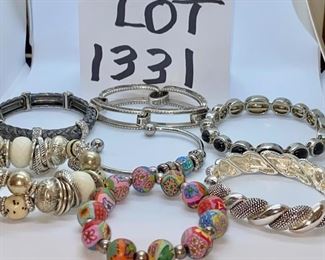 Lot 1331.  $95.00.  Lot of 7 Totally cool Bracelets.  Charcoal + Rhinestone stretchy bracelet, silver and black (obsidian?) magnetic closure bracelet, unbranded link bracelet silver tone, very cool silver tone chunky bracelet(looks to be designer, but no mark!), silver braided look bracelet stretch, silver cuff w/silver beads and one very neat blue bead-- stunning, Floral beads w/silver spacers on stretchy cord-- LOVELY!	