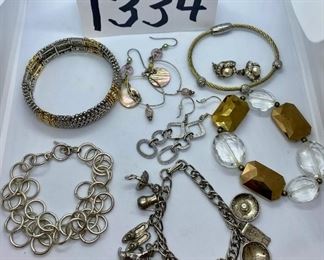 Lot 1334. $40.00. 5 costume jewelry earrings, including a charm bracelet (not sterling) and 3 pairs of earrings 		