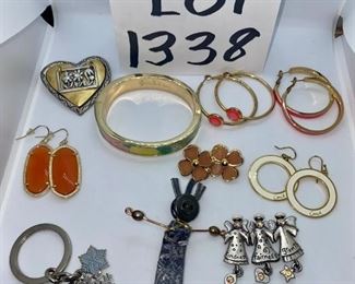 Lot 1338. 	$35.00.  Lot of costume jewelry with some good names like Coach, Kate Spade, Lilly Pulitzer, and a primitive pin.  (10 pc. costume jewelry. folk art pin, orange drop signed earrings, coach key fob w/snowflakes, coach white hoop drop earrings, kate spade pink hoops, lilly pulitzer bangle, 3 angel pin, flower earrings, primitive figurine pin, hoop earrings.	