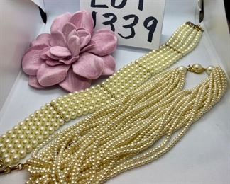 Lot 1339.  $34.00. Lot of three costume jewelry items - a multi-strand faux pearl necklace, very chic, a faux pearl choker by Arthur David and a large Pink Flower barrette or pin from the Gap.	