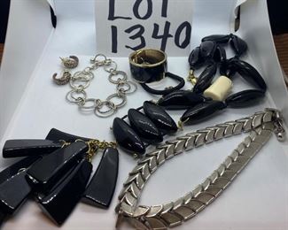 Lot 1340. $28.00.  A Random lot of jewelry includes a silver bracelet signed Trifari, a long necklace (black beads, one white one and very light by Chico's, a cool pair of pierced ear hugger earrings, a black ponytail holder that opens and then clips shut, and a silver chain bracelet.  		$28.00