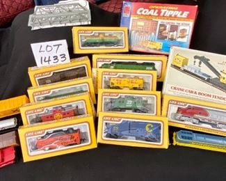Lot 1433.  $125.00. Huge Lot of HO Scale Trains including: 3 Powered Engines, Box Cars, Tankers and Accessories as well as Track, Transformers, Switches, and Trestle Bridge.		