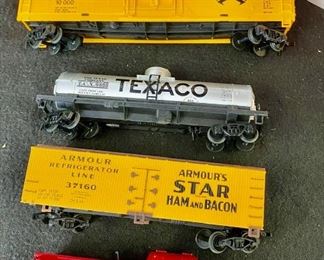 Lot 1433.  $125.00. Huge Lot of HO Scale Trains including: 3 Powered Engines, Box Cars, Tankers and Accessories as well as Track, Transformers, Switches, and Trestle Bridge.	