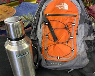 Lot 1482.  $65.00.  The North Face Borealis in Orange and Gray and Stanley Stainless Steel Thermos		