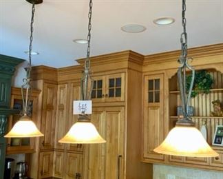Lot 975. $435.003 Pendant Lights in Kitchen with Wrought Iron Base by Fine Arts.