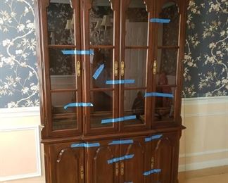 $750 (Photo #1)- Vintage Ethan Allen Georgian Court Cherry China Cabinet. Excellent condition. Glass in upper doors. Glass shelving. Lighted inside. Two lower outside doors cover one shelf. The 2 middle doors cover two drawers. (Photo with blue tape on hutch is to keep doors closed for moving)