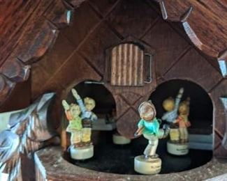 RARE (Photo #6) $380 - Goebel Hummel Dancing Figurines Musical Cuckoo Clock. Regula German Black Forest animated Swiss musical chalet Cuckoo Clock with dancing Hummel Goebel figurines. Deeply carved with a classic chalet design and wonderful detail. But what really makes this cuckoo clock stand out is the rare and adorable Hummel characters ! (see pics). Each figurine is stamped M.J. Hummel Goebel. The maker on this stunning Cuckoo Clock is Regula and is stamped 25 / 1-P. (not sure but assuming that this is the model and or the mechanism number.) Other numbers found on the brass mechanism are stamped G.M. 186 this may be the patent numbers for the mechanism. Also stamped, Made in Germany. Clock face, hands, pendulum, pine cone weights and figurines are in very good condition. The only minor cosmetic issue on this clock is down at the base. The small birds have chipped/broken and repaired wing tips. These are very small birds so you really don't notice it unless you get up very close