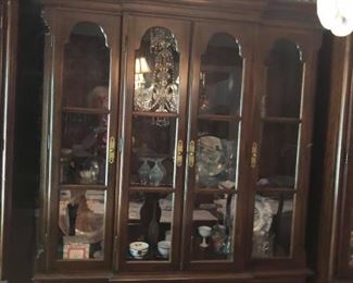 $750 - (Photo #2) Vintage Ethan Allen Georgian Court Cherry China Cabinet. Excellent condition. Glass in upper doors. Glass shelving. Lighted inside. Two lower outside doors cover one shelf. The 2 middle doors cover two drawers.