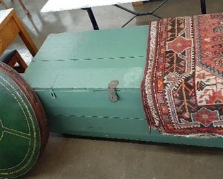 large trunk, poker table, area rug