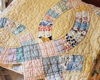 Several vintage hand sewn quilts