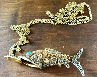 $45 Articulated  fish pendant/box on gold tone chain 