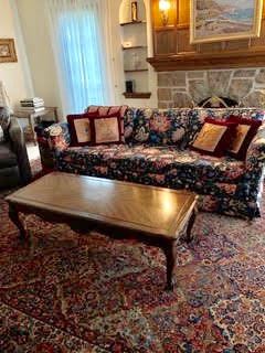 Floral sofa, coffee table & rug