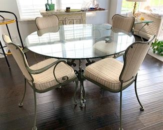 Outstanding, Round Pedestal, glass table with 4 wrought iron and upholstered chairs