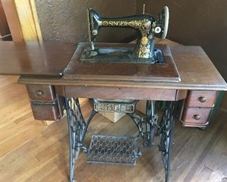 Singer sewing machine and cabinet. Date of manufacture is 1911 or 1912. It looks like all you need is a belt for it to work.