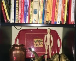 Books, plastic tray, copper vase is SOLD, bird figurine is SOLD, brass bookends are SOLD, wooden jointed figure