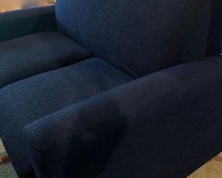 Small blue sofa with storage under seat cushions 