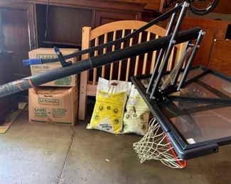 Basketball hoop includes base, pole, backboard, hoop