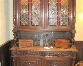 Heavily carved oak & stained glass Cupboard/Buffet de Corps with lights and carved Winged Griffins.