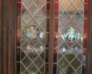 Heavily carved oak & stained glass Cupboard/Buffet de Corps with lights and carved Winged Griffins.