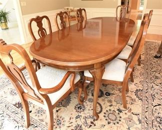 Mahogany Dining Table with Eight Chairs  $350
Some sun fading on end closest to windows. Heat damage to top in two spots. Excellent candidate for refinishing or painting. Includes two armchairs and six side chairs. Chairs have off-white upholstery and some have spots. Table is 42” wide, 30” tall, and 65” long. There are two 15” leaves that extend the table up to 7’11”