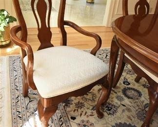 Mahogany Dining Table with Eight Chairs  $350
Some sun fading on end closest to windows. Heat damage to top in two spots. Excellent candidate for refinishing or painting. Includes two armchairs and six side chairs. Chairs have off-white upholstery and some have spots. Table is 42” wide, 30” tall, and 65” long. There are two 15” leaves that extend the table up to 7’11”