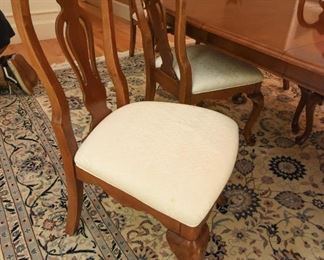 Mahogany Dining Table with Eight Chairs  $350
Some sun fading on end closest to windows. Heat damage to top in two spots. Excellent candidate for refinishing or painting. Includes two armchairs and six side chairs. Chairs have off-white upholstery and some have spots. Table is 42” wide, 30” tall, and 65” long. There are two 15” leaves that extend the table up to 7’11”