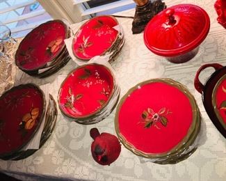 large set of red pottery dishware