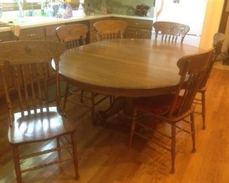 Large oak claw foot table with six chairs and another leaf.  Measure 74" long x 54" wide. Leaf is 19 1/2" .  Presale $275