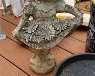 Several cement outdoor pieces plus a bottle tree, wooden crates,