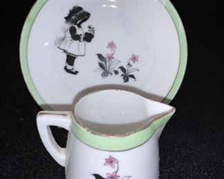 pottery creamer and saucer with girl and flowers green/pink