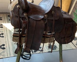 Wells Fargo Saddle with Blanket - $2,600; US Leather Saddle Bag - $350; Primitive Saddle Stand - $300