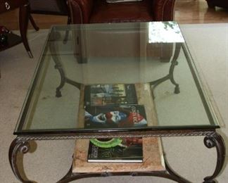 Iron Scroll Leg Coffee Table Supporting a Glass Top and a Marble Shelf