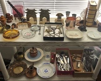 Vintage ashtrays, brass bookends, bottle openers (some advertising), Karlsberg beer items, brass watering can, set of Rogers “Bamboo” stainless flatware