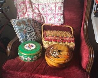 Burgundy velvet wingback chair, crocheted tablecloth, raffia sewing basket, tin