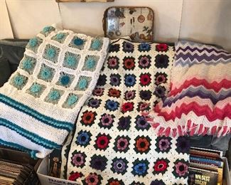 Crocheted bedspread (on left), afghans