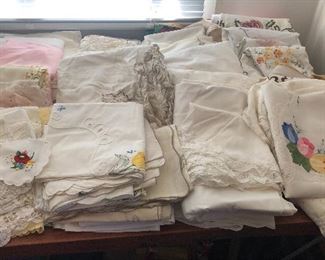 Still more linens - lace tablecloths, embroidered tea towels & runners