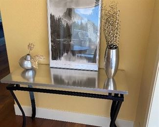  This table has a brushed metal top, was made to order. Wrought iron base.  $90.00