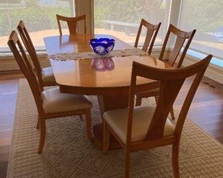 Absolutely beautiful light maple color table, with leaves in is 92 in. in length. Two leaves , each is 14 in. Very glossy finish. Chairs have been professionally re-upholstered in faux leather. $1,200