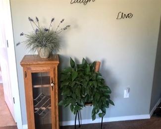 small cabinet, indoor plants, wall art