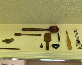 Kitchen items hanging above door -carved and metal