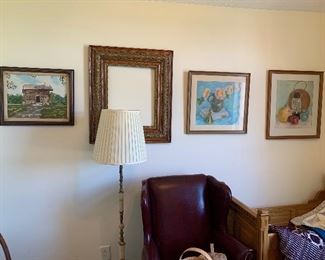 A corner of one bedroom; Large antique frames. Leather wing back with ottoman; Akro Agate or marble floor lamp