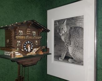 Vintage cuckoo clock and a signed Bob Cat photo 