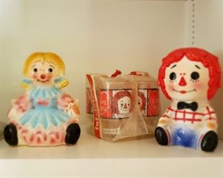 Raggedy Ann & Andy floral vases and a set of four unopened Anchor Hocking Raggedy Ann glasses