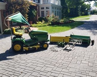 John Deere LX277 AWS, 48 inch deck. Also, 42 inch snow blade with tire chains, wheel weights and angler arm, seeder/aerator, John Deere logo umbrella,  tractor buddy trash can 