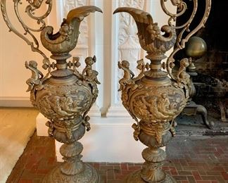 $225 Pair of two-tone standing metal urns with cherubs.  25.5"H x 10"W 