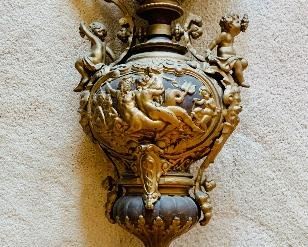 Detail:  Pair of two-tone standing metal urns with cherubs.  25.5"H x 10"W 